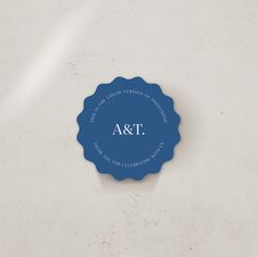 a blue seal with the word ast on it sitting on a white table top