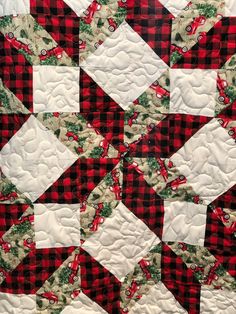 a red and black quilt with white squares on it