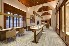 the inside of a jewelry store with lots of glass cases on display and wooden shelves