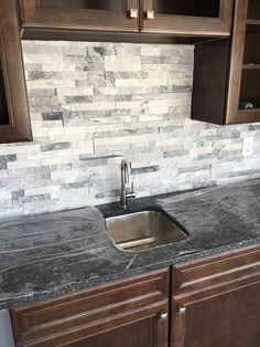 a kitchen counter top with a sink and wooden cabinets