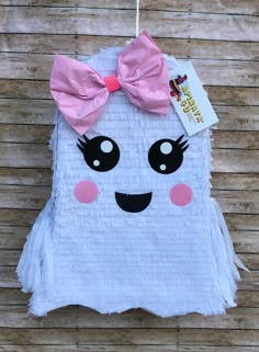 a white piece of paper with a pink bow on it's head and eyes