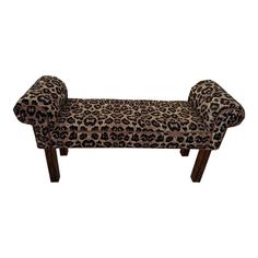 a leopard print bench with wooden legs