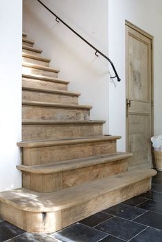 a set of wooden stairs leading up to a door