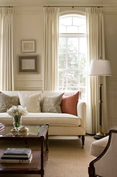 a living room filled with furniture and windows