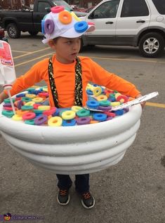 a young boy wearing an inflatable pool with doughnuts and sprinkles on it