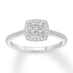 a square shaped diamond ring with pave set diamonds on the band and shoulders in white gold