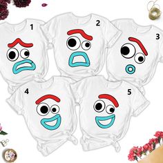 four t - shirts with faces drawn on them