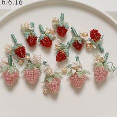 there is a plate that has some strawberries and pearls on it, all in different colors