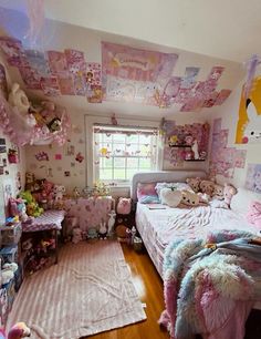 a bedroom decorated in pink and white with lots of stuffed animals