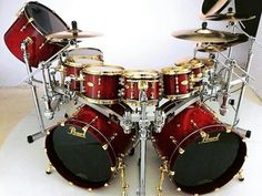 a red and black drum set with gold hardware