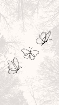 three butterflies flying in the air over trees