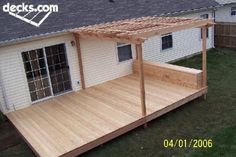 a wooden deck in front of a white house