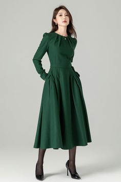 "Green long sleeve wool swing dress with a stylish folded neckline. This dress effortlessly blends elegance and comfort. The flared silhouette offers a graceful and flattering fit, while the high-quality wool fabric ensures warmth and softness. The folded neckline adds a touch of sophistication to this versatile dress, perfect for various occasions. DETAIL * 30% wool, 30% fiber, 40% polyester * fully satiny lining, more nice to the touch body * Round pleated neckline * Long sleeves * Fit and fla Elegant Full Skirt Dress For Fall, Chic Long Sleeve Dress For Fall Wedding, Fitted Long Sleeve A-line Dress For Winter, Fitted A-line Long Sleeve Winter Dress, Chic Long Sleeve Wool Midi Dress, Chic Wool Midi Dress With Long Sleeves, Fitted Long Sleeve Fall Wedding Dress, Fall Wedding A-line Midi Dress, Wool Long Sleeve Midi Dress For Spring