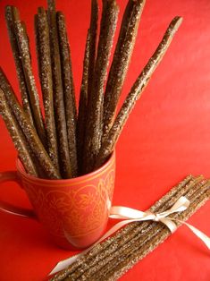 a cup filled with crackers on top of a red table