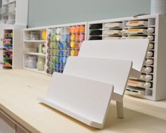 there are many craft supplies displayed on the counter in this room, including paintbrushes and markers