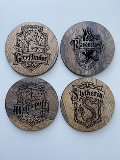 four coasters with harry potter logos on them