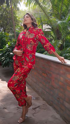 Make heads turn with out printed co-ord set in silk. Straight Pants with Blazer Jacket. Made in printed raw silk. Color : Red. Fully lined. No of Components : 2. Model height is 5.6” and is wearing a size S. Wash Care : Dry Clean Only. Festive Long Sleeve Loungewear Pant Set, Festive Printed Silk Sets, Long Sleeve Sets With Printed Motifs For Loungewear, Casual Silk Long Sleeve Sets, Casual Silk Sets With Long Sleeve, Festive Silk Printed Sets, Festive Silk Pant Set With Floral Print, Festive Silk Pant Set With Printed Motifs, Festive Red Printed Set