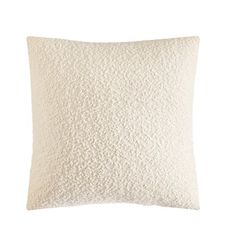 a white pillow that is made out of wool and has a textured pattern on the front