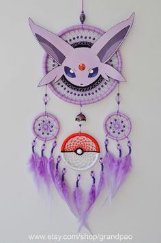 a pink and purple dream catcher with a pikachu face