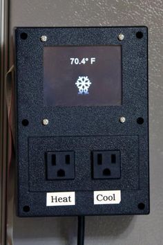 an electrical outlet on the wall with two wires attached to it and a timer panel