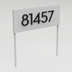 a white sign with black numbers on it that reads 81457 and stands in front of a gray background