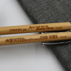 two wooden pens sitting next to each other on top of a piece of cloth,