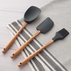 three cooking utensils on a striped towel