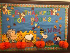 a bulletin board that says we're grateful for books with peanuts and pumpkins