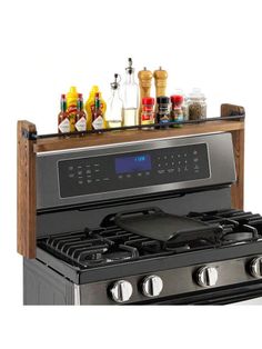 a black stove top oven sitting next to a counter with spices and condiments on it