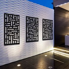 a modern bathroom with black and white tiles on the wall, along with two sinks