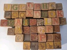 old wooden letter blocks are stacked up on top of each other