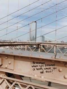 graffiti written on the side of a bridge