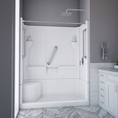 a walk in shower sitting next to a white sink