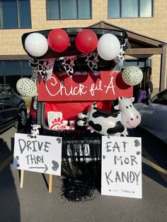 a car decorated with balloons and decorations for a drive thru