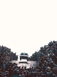 a large group of people standing in front of a car