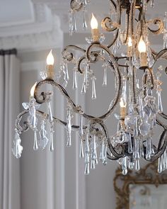 an ornate chandelier with clear crystal drops hanging from it's centerpiece