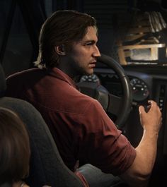 a man sitting in the driver's seat of a car with his hand on the steering wheel