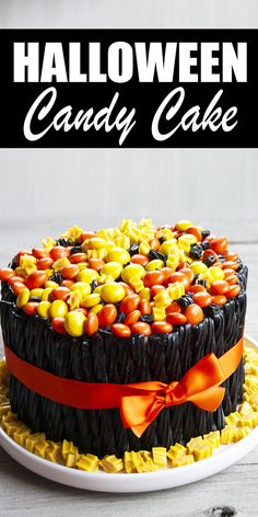 a halloween candy cake on a plate with the title overlaying it in black and white