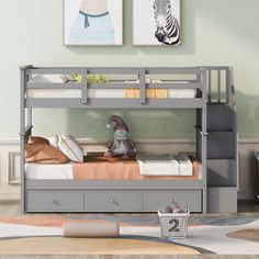 a gray bunk bed with drawers underneath it