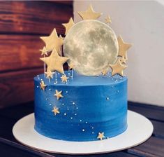 a blue cake with stars and the moon on top