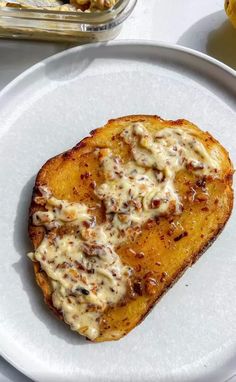 a white plate topped with two pieces of bread covered in cheese