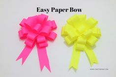 two different types of bows on a white surface with one being pink and the other is yellow