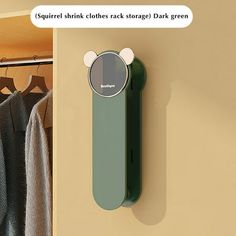 a bear shaped object is mounted on the wall next to a coat rack and clothes