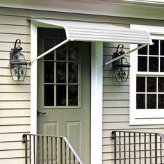 the front door of a house with an awning over it