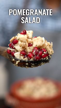 pomegranate salad is being held by a spoon with the words pomegranate salad on it