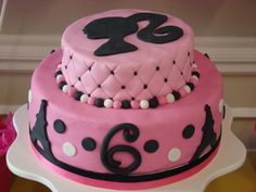 a pink cake with black and white designs on it