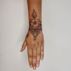 a woman's hand with a tattoo on it