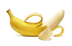 two peeled bananas and one cut in half on a white background with clippings