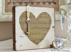 a heart shaped clock sitting on top of a white shelf next to a framed mirror