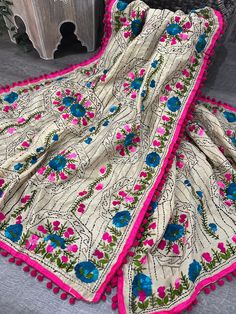 Beige Cotton Silk dupatta with Phulkari embroidery and cute pom pom lace in pink. Multicolor Embroidered Pashmina Dupatta With Chikankari, Bohemian Pink Dupatta With Pallu, Multicolor Chikankari Embroidered Dupatta Shawl, Multicolor Floral Embroidered Dupatta Shawl, Yellow Phulkari Dupatta, Pom Pom Lace, Phulkari Embroidery, Phulkari Dupatta, Beige And Pink